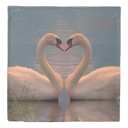 Two swans facing each other making heart with neck duvet cover