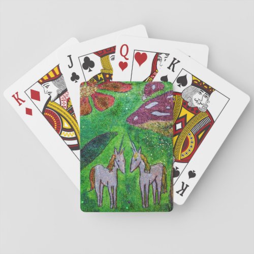 Two unicorns under a mushroom playing cards