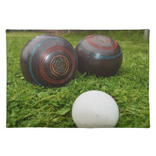 Two Vintage Brown Lawn Bowls On Grass, Cloth Placemat