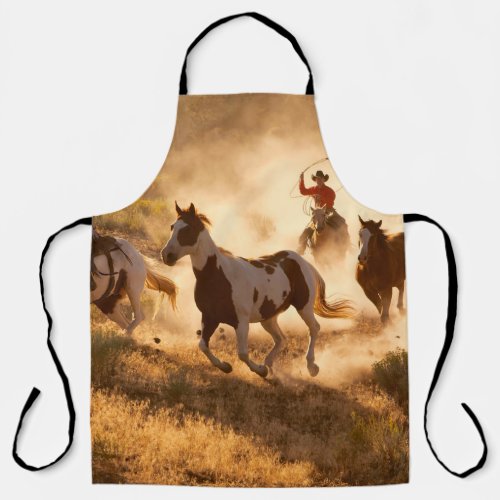 Two western cowboys riding horses roping wild hor apron