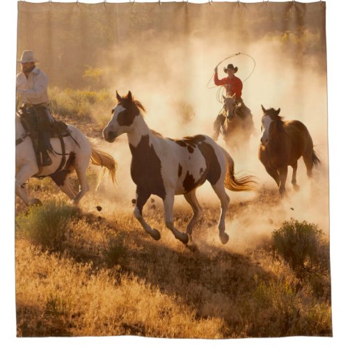 Two western cowboys riding horses roping wild hor shower curtain