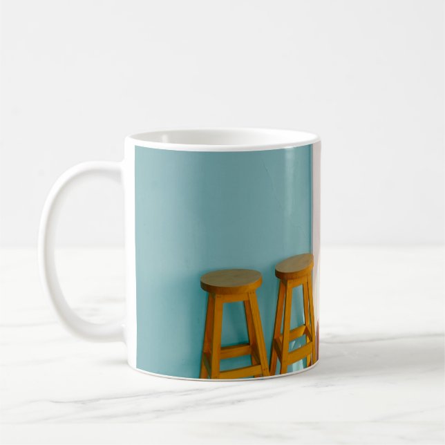 Two yellow wooden bar stools coffee mug (Left)