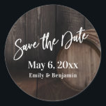 Typography Save the Date Brown Wooden Barrel Classic Round Sticker<br><div class="desc">This piece is covered in an image that includes part of a wooden barrel against a dark rustic brown wall. Perfect for your whiskey, wine, brewery, winery or other rustic-themed wedding celebration. Using a modern handwriting script font, I created a simple, bold typography graphic image that reads "Save the Date"....</div>