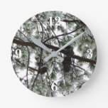 Underneath the Snow Covered Pine Tree Winter Photo Round Clock