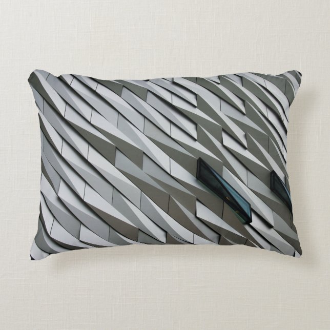 Undulating abstract shapes on a building facade at accent pillow (Front)