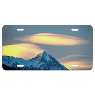 Unique Clouds Over Snow Covered Mountains License Plate