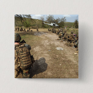 US Marines provide security as a UH-1N Button