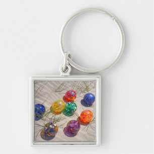 USA, Oregon. Colorful Glass Floats On Sand Dune Keychain