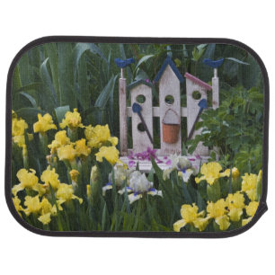 USA, Pennsylvania. Garden irises grow around Car Floor Mat
