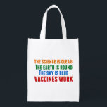Vaccines Work Pro Vaccination Science Quote Grocery Bag<br><div class="desc">Hillary Clinton quote on vaccination: the science is clear: the earth is round, the sky is blue, vaccines work. Colorful reusable grocery bag to bring awareness to the measles outbreaks and the Covid pandemic. Please vaccinate your children to prevent the spread of diseases and illness.</div>