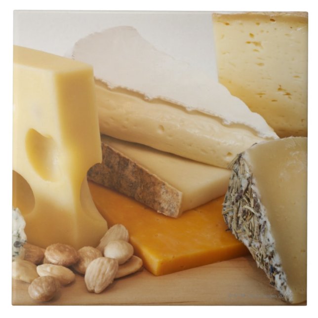 Various cheeses on chopping board ceramic tile (Front)
