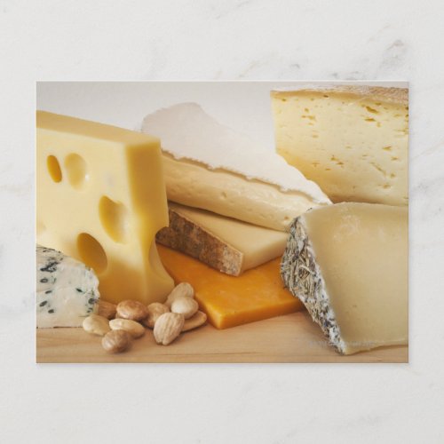 Various cheeses on chopping board postcard