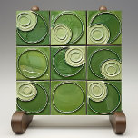 Verdant Swirl Faux Relief Ceramic Tile<br><div class="desc">This exquisite ceramic tile features a hypnotic swirl design that evokes the lush and varied greens of a verdant forest. The piece is a symphony of green hues ranging from the pale, soft tones of sage to the deep, rich shades of hunter-green. The glossy finish of the tile reflects light...</div>