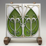 Verdant Vines Art Nouveau Ceramic Tile<br><div class="desc">This beautifully crafted ceramic tile is a tribute to the Art Nouveau style, featuring fluid and organic vine-like designs in varying shades of verdant green. The sinuous lines flow in a harmonious pattern, outlined by metallic silver that provides a striking contrast against the lush greens and the creamy ivory background....</div>