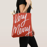 Very Merry Lettering Christmas Tote Bag<br><div class="desc">Bold hand lettering of "very merry" over custom color and choice of bag type.</div>