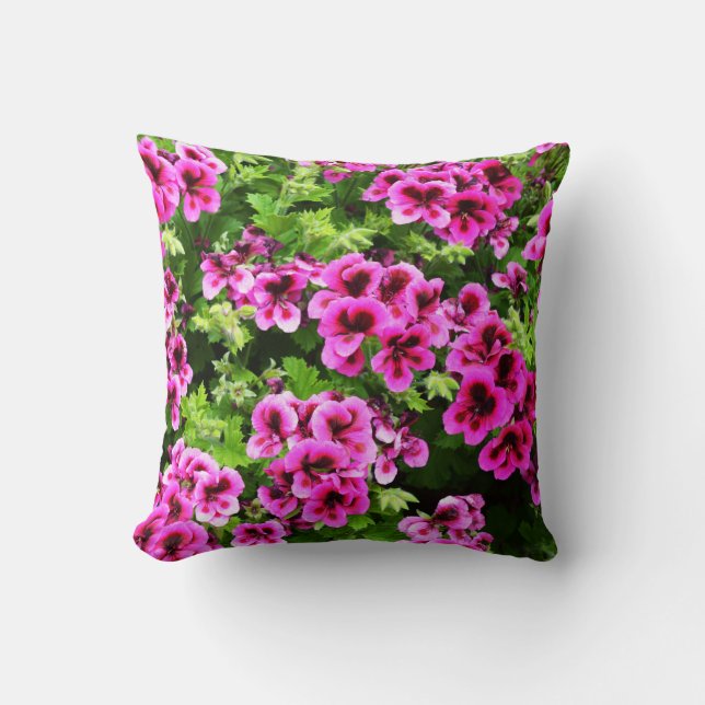 "Vibrant Blooms: Hot Pink Geraniums on Lush Bush Throw Pillow (Front)