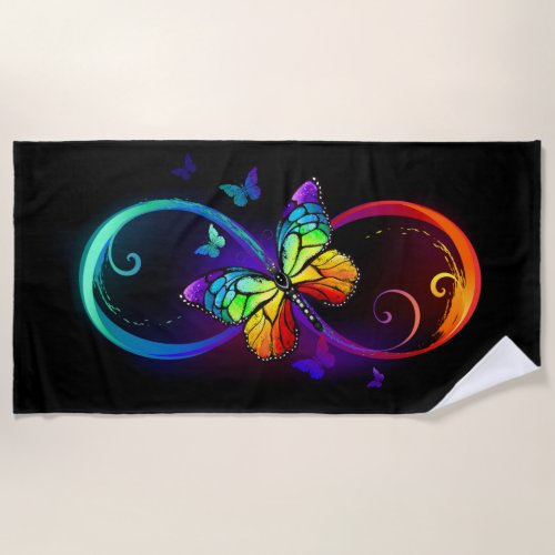 Vibrant infinity with rainbow butterfly on black beach towel