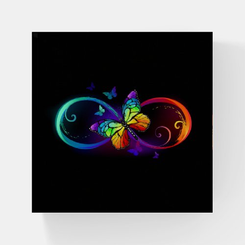 Vibrant infinity with rainbow butterfly on black paperweight