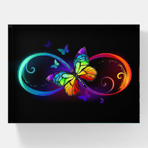 Vibrant infinity with rainbow butterfly on black paperweight