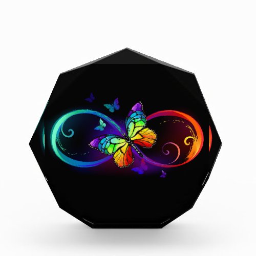 Vibrant infinity with rainbow butterfly on black photo block