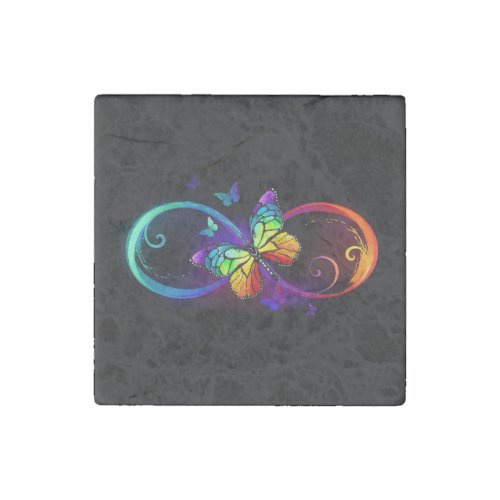 Vibrant infinity with rainbow butterfly on black stone magnet