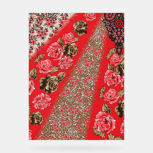 Vibrant red fabric featuring intricate floral and  acrylic sign
