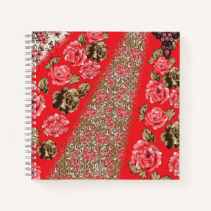 Vibrant red fabric featuring intricate floral and  notebook