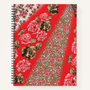 Vibrant red fabric featuring intricate floral and notebook