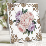 Victorian Peony Bouquet with Gold Scrollwork Ceramic Tile<br><div class="desc">This exquisite Victorian-inspired ceramic design features a delicate bouquet of pink and lavender peonies at its center, surrounded by intricate golden scrollwork on a crisp white background. The floral arrangement radiates timeless elegance, perfect for adding a touch of luxury to kitchens, bathrooms, or decorative accents. The ornate detailing and soft...</div>