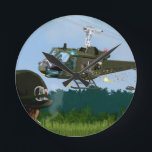 Vietnam War Bell Huey. Round Clock<br><div class="desc">American Bell Huey Strafes enemy forces in grasslands whilst attempting  GI rescue... .</div>
