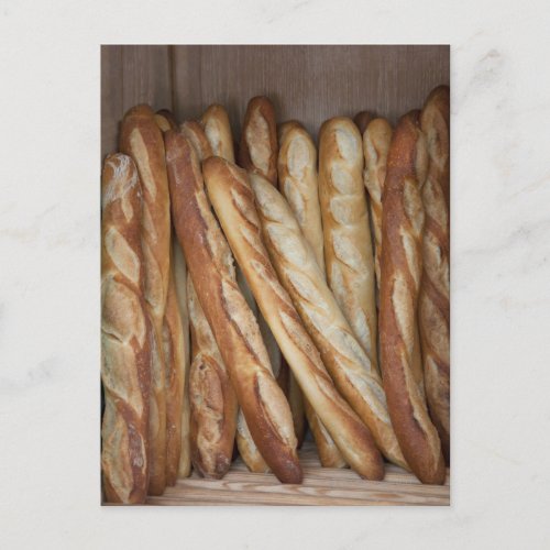 view of bread loaves in bakery window display postcard
