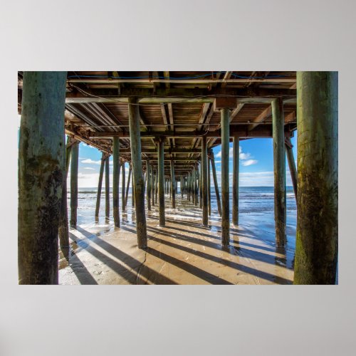 View of the ocean from under the pier poster