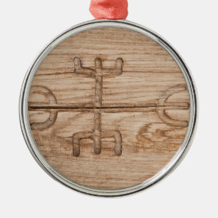 Viking rune on cracked wood metal ornament