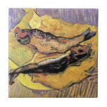 Vincent Van Gogh - Still Life Bloaters Fine Art Tile<br><div class="desc">Vincent Van Gogh's Still Life Bloaters On A Piece Of Yellow Paper. Oil on canvas from 1889 showing two bloater fish, or herring, sitting on a yellow plate and paper on a table against a violet background. Unlike similar stores, Art Lover's Cafe features classic, high resolution works of art that...</div>