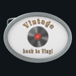Vintage - Back to Vinyl, the record is back Belt Buckle<br><div class="desc">The design features a stylized black vinyl record with realistic grooves and a glossy effect. The middle label is red and contains the words “50s, 60s, 70s, 80s, 90s” arranged in a circle around the middle - a homage to the musical decades. Above the record, the word “Vintage” is shown...</div>