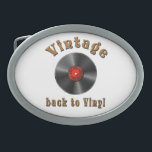 Vintage - Back to Vinyl, the record is back Belt Buckle<br><div class="desc">The design features a stylized black vinyl record with realistic grooves and a glossy effect. The middle label is red and contains the words “50s, 60s, 70s, 80s, 90s” arranged in a circle around the middle - a homage to the musical decades. Above the record, the word “Vintage” is shown...</div>