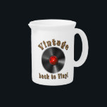 Vintage - Back to Vinyl, the record is back Beverage Pitcher<br><div class="desc">The design features a stylized black vinyl record with realistic grooves and a glossy effect. The middle label is red and contains the words “50s, 60s, 70s, 80s, 90s” arranged in a circle around the middle - a homage to the musical decades. Above the record, the word “Vintage” is shown...</div>