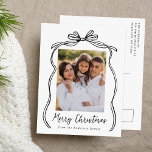 Vintage Black Bow Merry Christmas Photo Holiday Postcard<br><div class="desc">Celebrate the holiday season with this charming Christmas postcard featuring your family's photo framed by a festive black bow and ribbon on a crisp white background. "Merry Christmas" is elegantly written in a charming black handwritten script, with space to personalize your family name below. The back of the postcard displays...</div>