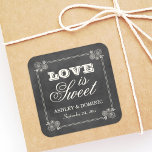 Vintage Black Chalkboard Wedding Love is Sweet Square Sticker<br><div class="desc">Whimsical wedding favor stickers in a square shape feature "Love is Sweet" with a monogram of the bride and groom names and wedding date and floral frame design with a soft white chalk appearance on a rustic black board background with textured look.</div>