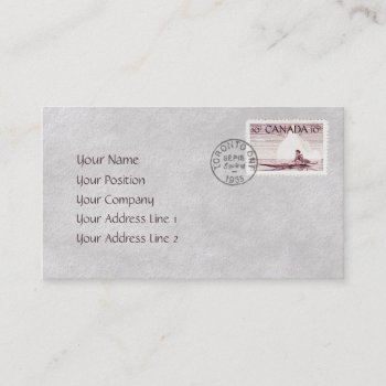 A business card that looks like a vintage stamped addressed envelope with an eskimo in a kayak on a calm sea with an iceberg in the background, and a passenger jet in the skies above