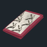 Vintage Canada Geese in Flight Engraving Trifold Wallet<br><div class="desc">Capture the timeless majesty of wild migration with this stunning vintage-style illustration. A graceful flock of Canada geese soars across the sky in dynamic formation, their powerful wings spread wide and detailed feathers meticulously rendered in classic black ink etching. The intricate line work and subtle shading evoke antique ornithology prints,...</div>