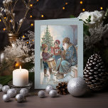 Vintage Father Christmas with Children Holiday Card<br><div class="desc">Kindly old Father Christmas in blue robes sits with children,  one with a book and one with a drum,  with Christmas tree in background. Custom blue textured background. Inside features complementary background graphics and editable text fields.</div>