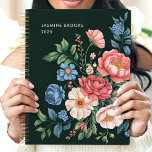 Vintage Garden Botanical Custom Name Floral Planner<br><div class="desc">This exquisite design showcases a lush arrangement of vintage-inspired garden blooms in pink, blue, cream, and coral hues, set against a deep green background. Personalized with a custom name and the year 2025, it offers timeless elegance and sophistication. Perfect for nature enthusiasts, garden lovers, or anyone drawn to classic floral...</div>