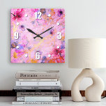 Vintage gold pink floral watercolor romantic chic square wall clock<br><div class="desc">Bold, white easy-to-read numerals, along with pink, purple, and blue watercolor flowers, overlay gold script on a gorgeous, pink, purple, and gold veined background. Enliven up your favorite room with this chic, stunning, stylish wall clock. Your choice of a round or square clock face. Makes a wonderful, elegant statement in...</div>