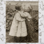 Vintage Love Photo of Children Kissing in a Garden Jigsaw Puzzle<br><div class="desc">Vintage black and white sepia photo of two children kissing in the garden. An adorable picture of a little boy and girl and their first kiss. Darling picture of youth and innocence.</div>