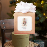 Vintage Nutcracker & Merry Christmas Square Sticker<br><div class="desc">A beautifully illustrated vintage-style Nutcracker soldier, resplendent in his classic attire, stands tall, holding a Merry Christmas banner. The rich, warm colors and intricate details evoke a sense of yuletide nostalgia, making it a perfect choice for those who appreciate the classic holiday aesthetics. May your holiday season be filled with...</div>