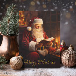 Vintage Santa Reading a Book Holiday Card<br><div class="desc">Send warm holiday wishes with this charming Christmas card featuring a vintage Santa reading a book and the classic text "Merry Christmas." Perfect for sharing nostalgic holiday spirit, this card captures the cozy magic of Christmas past. The back is customizable, allowing you to add your own heartfelt message or greeting...</div>