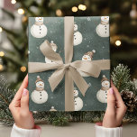Vintage Snowmen on Sage Green  Wrapping Paper<br><div class="desc">Bring a touch of vintage charm to your holiday gifts with this Vintage Snowmen on Sage Green Wrapping Paper. Featuring adorable and realistic snowmen in a minimalist design, this neutral-colored wrapping paper offers a soft, cozy feel with a modern twist. The subtle sage green background adds a calming, festive tone...</div>