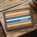 Vintage Surfboard Stripes - Subtle Wood Background Trifold Wallet<br><div class="desc">A colorful,  retro stripe design in blue and orange on a faux wood print background. A vintage surfboard stripe design with a beach and surf look. Add your name or monogram to make this a personal item that will stand out amongst your friends. The name is a chunky font.</div>