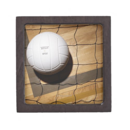 Volleyball and net on hardwood floor of jewelry box